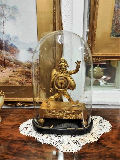 Georgian gilt clock with dome glass case on stand