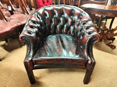 Button back leather armchair